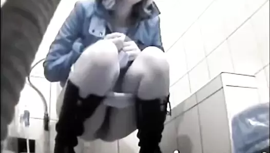 Girl in black boots scat squatting
